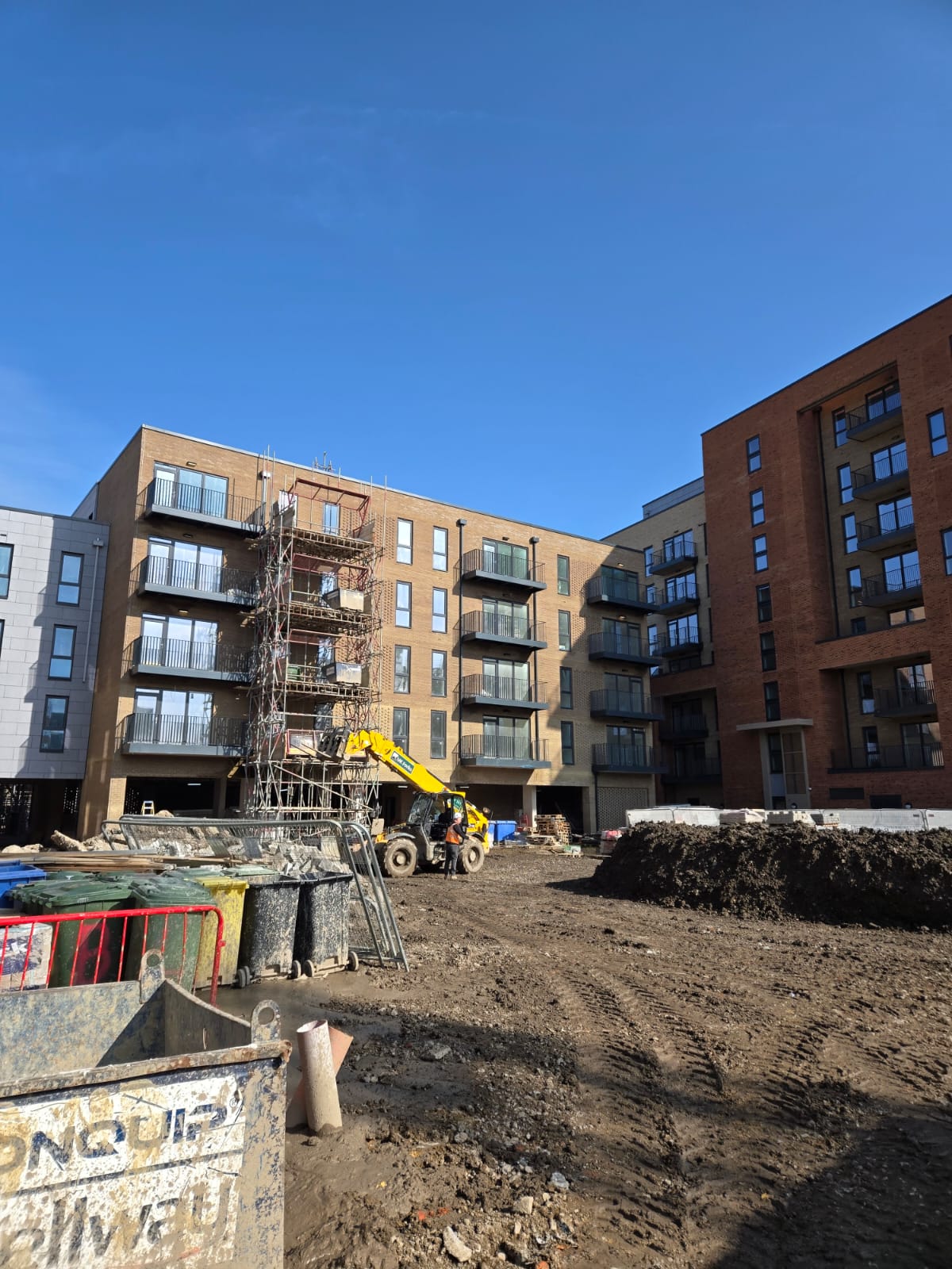 Apartment buildings across a residential development during active property operations.